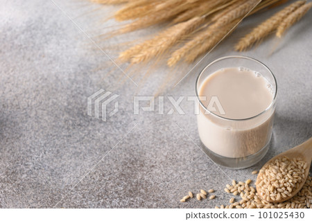 Vegan Barley milk in glass, plant based milk replacer. 101025430