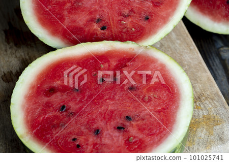 Ripe red watermelon with black seeds 101025741