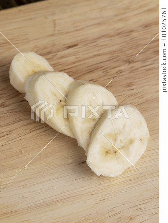 a ripe sweet banana cut into pieces lies on the table a ripe sweet banana cut into pieces lies on the table 101025761