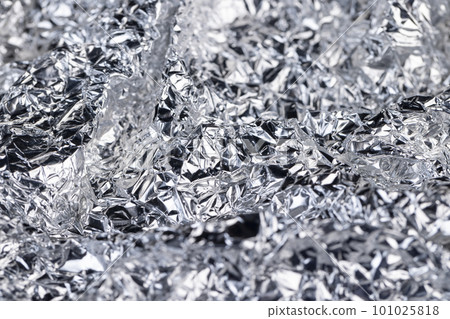 crumpled thin aluminum foil reflecting light 101025818