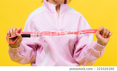 Adorable female child with skipping rope jumping in studio Adorable female child with skipping rope jumping in studio 101026160