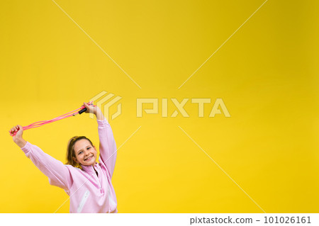 Adorable female child with skipping rope jumping in studio Adorable female child with skipping rope jumping in studio 101026161