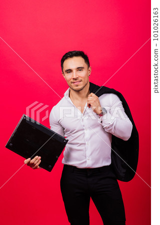 Image of young cheerful businessman in watch holding and using laptop isolated over red background Image of young cheerful businessman in watch holding and using laptop isolated over red background 101026163