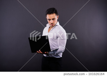 Cheerful young guy 20s in classic shirt isolated on dark wall background studio portrait. 101026164