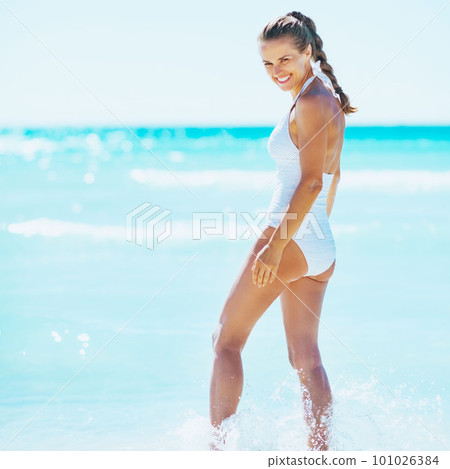 happy young woman walking in sea happy young woman walking in sea 101026384