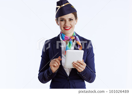 happy modern air hostess woman on white using tablet PC 101026489
