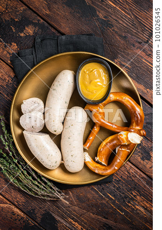 Munich white sausage with pretzel and mustard. Wooden background. Top view 101026545