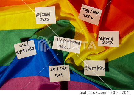MY PRONOUNS ARE Neo pronouns concept. Rainbow flag with paper notes text gender pronouns hie, e, ne, xe, ze, tey. Non-binary people rights transgenders. Lgbtq community support assume my gender 101027043