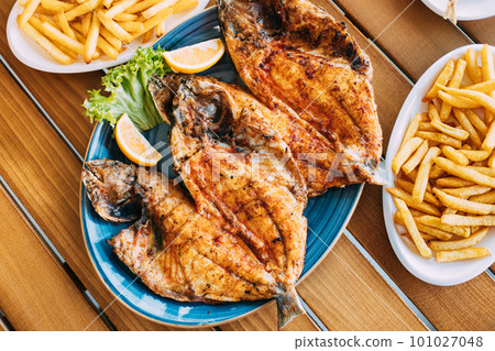 Dish with Gilt-head bream Fish With orange and french fries. Dorada, Dorade, dorado, Dourada fish and chips 101027048
