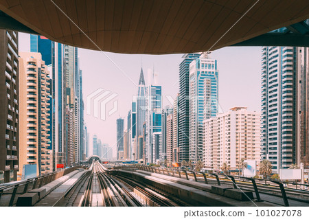 Modern Dubai Metro. Metro railway among glass skyscrapers in Dubai. Traffic on street in Dubai. Urban city background. Modern with skyscrapers architecture of Dubai, UAE 101027078