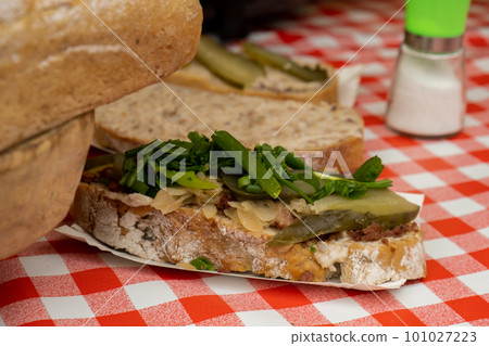 Sandwiches with rillettes, meat pate and pickled cucumber on street food market. Traditional polish sandwich with fat and pickles, old market, old town Gdansk, Poland 101027223