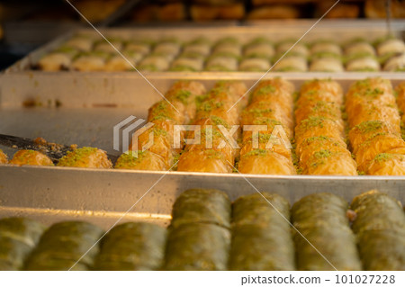 Various types or many colorful assortment of Turkish sweets for sale in street shop food festival. Baklava and pastries are sold on trays on the counter. Travel  101027228