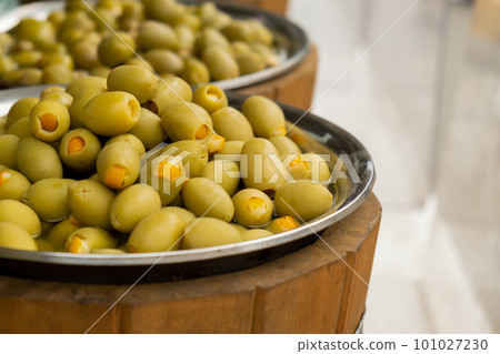 Different marinated olives and local food on street market in Gdansk, Poland. Selling and buying street food. Assortment of Appetizing olives on market 101027230