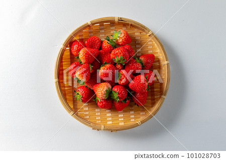 Strawberries in a colander on a white background 101028703
