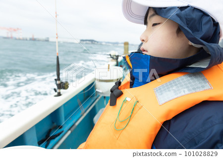 boy enjoying sea fishing boy enjoying sea fishing 101028829