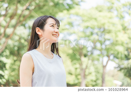 A smiling Asian woman in the green (relaxed / fully recovered) A smiling Asian woman in the green (relaxed / fully recovered) 101028964