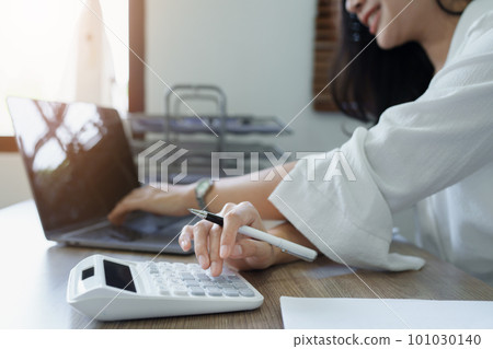 Accountants, Asian auditors are using calculators and computers to review annual tax budgets to submit information to the IRS Accountants, Asian auditors are using calculators and computers to review annual tax budgets to submit information to the IRS 101030140