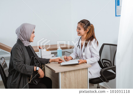 a female patient pointing on the medical check up paper a female patient pointing on the medical check up paper 101031118