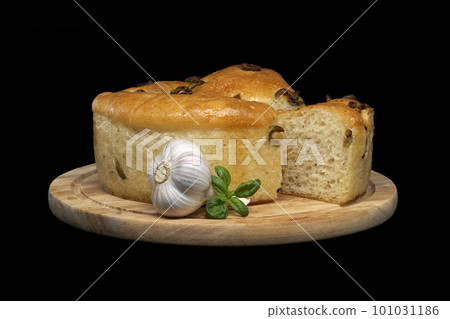 Focaccia bread with olives on black background Focaccia bread with olives on black background 101031186