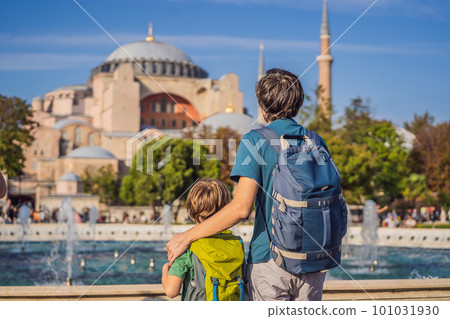 Father and son Tourists enjoy beautiful view on Hagia Sophia Cathedral, famous islamic Landmark mosque, Travel to Istanbul, Turkey. Traveling with kids concept. Sunny day architecture and Hagia Sophia 101031930