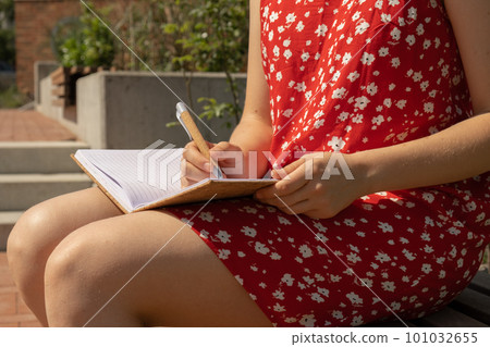 Unrecognizable Young woman in red dress Writing Gratitude Journal on wooden bench. Today I am grateful for. Self discovery journal, self reflection creative writing, self growth personal development 101032655