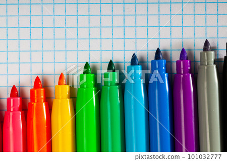 Opened multicolored markers on notebook, nobody 101032777