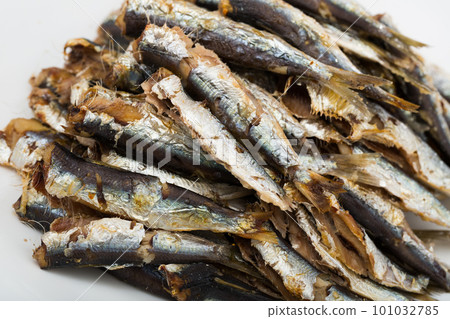 Deliciously cooked baked sprats served on white plate at table 101032785