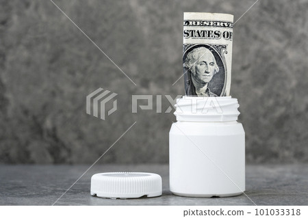 One dollar banknote rolled in the pharmaceutical bottle One dollar banknote rolled in the pharmaceutical bottle 101033318