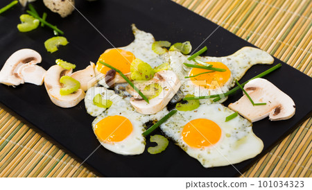 Fried quail eggs with champignons Fried quail eggs with champignons 101034323