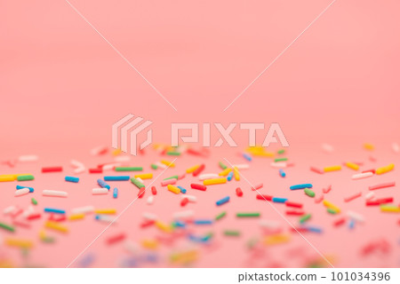 colorful sprinkles over pink background copy space 101034396