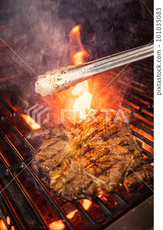 Beef steak on the grill with flames Beef steak on the grill with flames 101035083