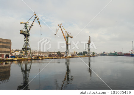 Motlawa river to Baltic Sea. Coal mine, polluting environment by the river POV from ferry swimming on river canal. Industrial building at the Gdansk Shipyard. Prefabrication workshop Motlawa river to Baltic Sea. Coal mine, polluting environment by the river POV from ferry swimming on river canal. Industrial building at the Gdansk Shipyard. Prefabrication workshop 101035439