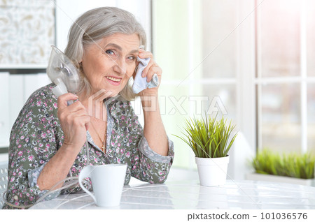 Portrait of elderly woman with flu inhalation 101036576