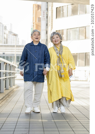 Smiling senior couple walking in the city Smiling senior couple walking in the city 101037429