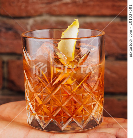 Male hand holds glass of whiskey Male hand holds glass of whiskey 101037591