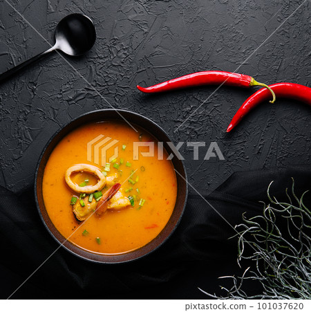 Tom yam seafood soup from above on black stone Tom yam seafood soup from above on black stone 101037620