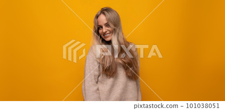 european girl smiling on yellow background 101038051