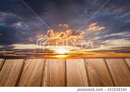 Textured wooden board table in front of beautiful on  background cloud and sunset light. Ready for home decoration 101038384