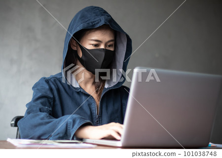 Professional hacker women Wearing a blue shirt with a hood Stealing data from online computer systems By releasing viruses into the system By using laptops and keyboards concept of malware and hacker Professional hacker women Wearing a blue shirt with a hood Stealing data from online computer systems By releasing viruses into the system By using laptops and keyboards concept of malware and hacker 101038748