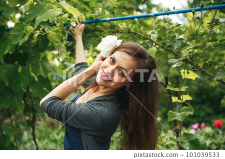 Happy young woman enjoying sunset in nature. Portrait of smiling girl 101039533