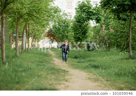 Child having fun and enjoy a weather. All kids love play with stick. 101039546