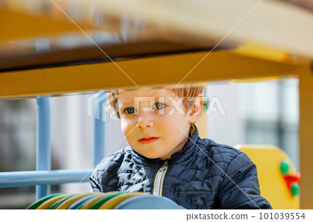 Children are enjoying athletic playground equipment. The kid plays Children are enjoying athletic playground equipment. The kid plays 101039554