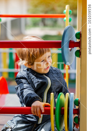 Little boy is rolling downhill in the courtyard. A child on a sports playground 101039556