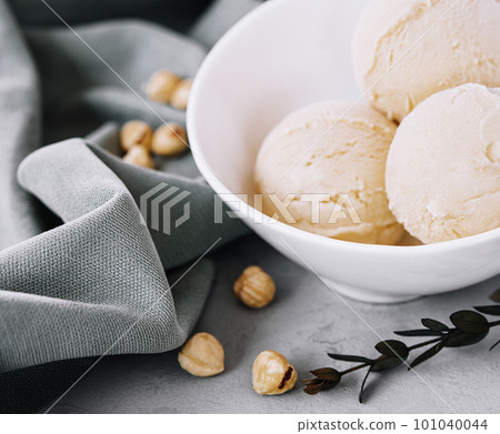 Delicious ice cream with hazelnut close up Delicious ice cream with hazelnut close up 101040044