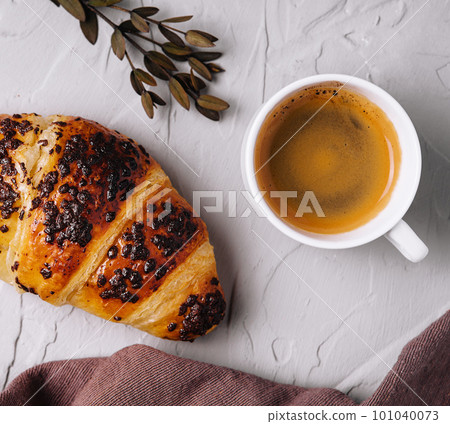 Coffee and croissant on stone table Coffee and croissant on stone table 101040073