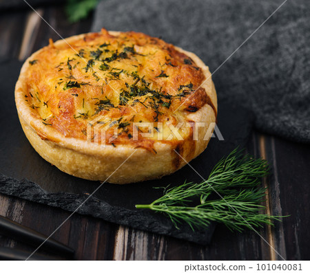 Cheddar cheese and spring onion omelette tarts served on wooden board Cheddar cheese and spring onion omelette tarts served on wooden board 101040081