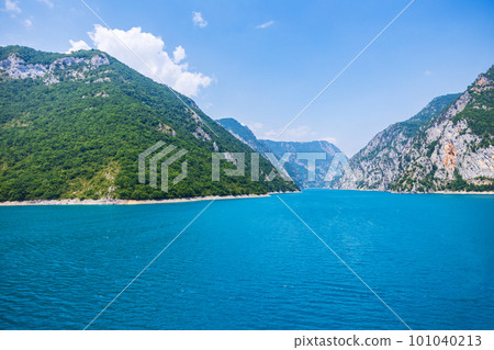 Landscape view of big lake between mountains at summer day Landscape view of big lake between mountains at summer day 101040213