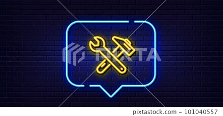 Neon light speech bubble. Spanner and hammer line icon. Repair service sign. Fix instruments symbol. Neon light background. Spanner tool glow line. Brick wall banner. Vector 101040557