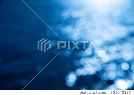 Blue ball bokeh on sparkling water surface Blue ball bokeh on sparkling water surface 101040587