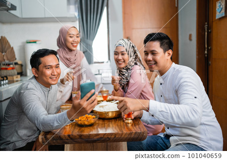 friends taking their picture together using a smartphone 101040659